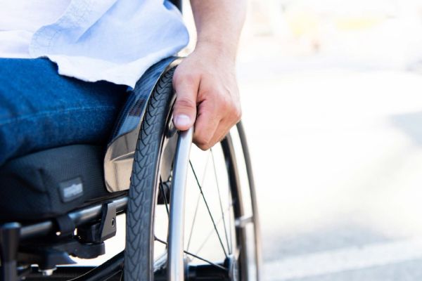 wheelchair user with hand on push rim