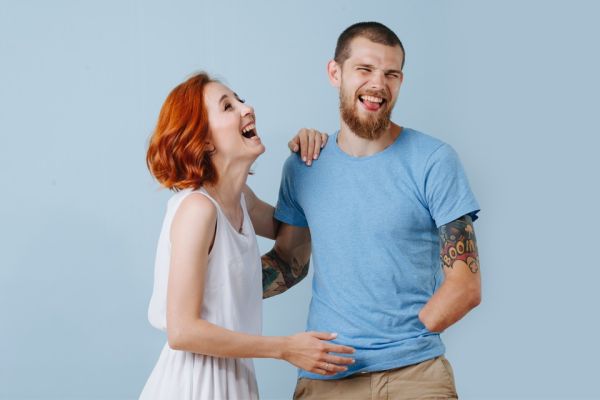 Young woman and young arm amputee man laughing