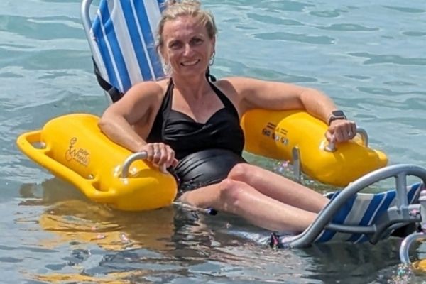 woman floating in beach wheelchair