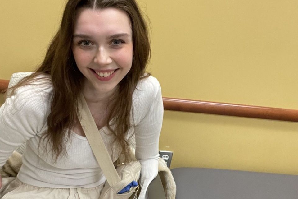 Four-way amputee teenager Amalie Henze smiling in clinic setting